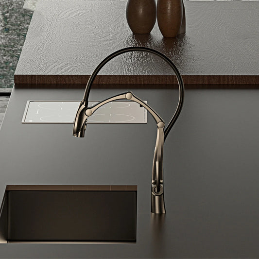 Modern kitchen faucet on a dark countertop with a metallic finish