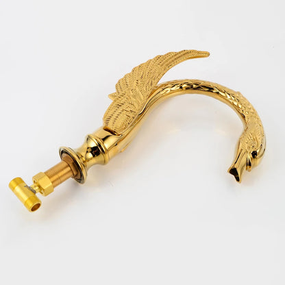 Gold door handle with a decorative design on a white background