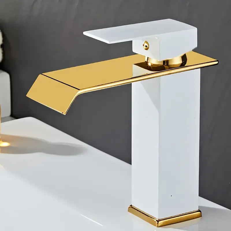 Gold and white faucet on a gray background