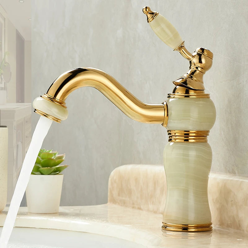 Luxurious gold and marble faucet with water flowing in a bathroom setting.