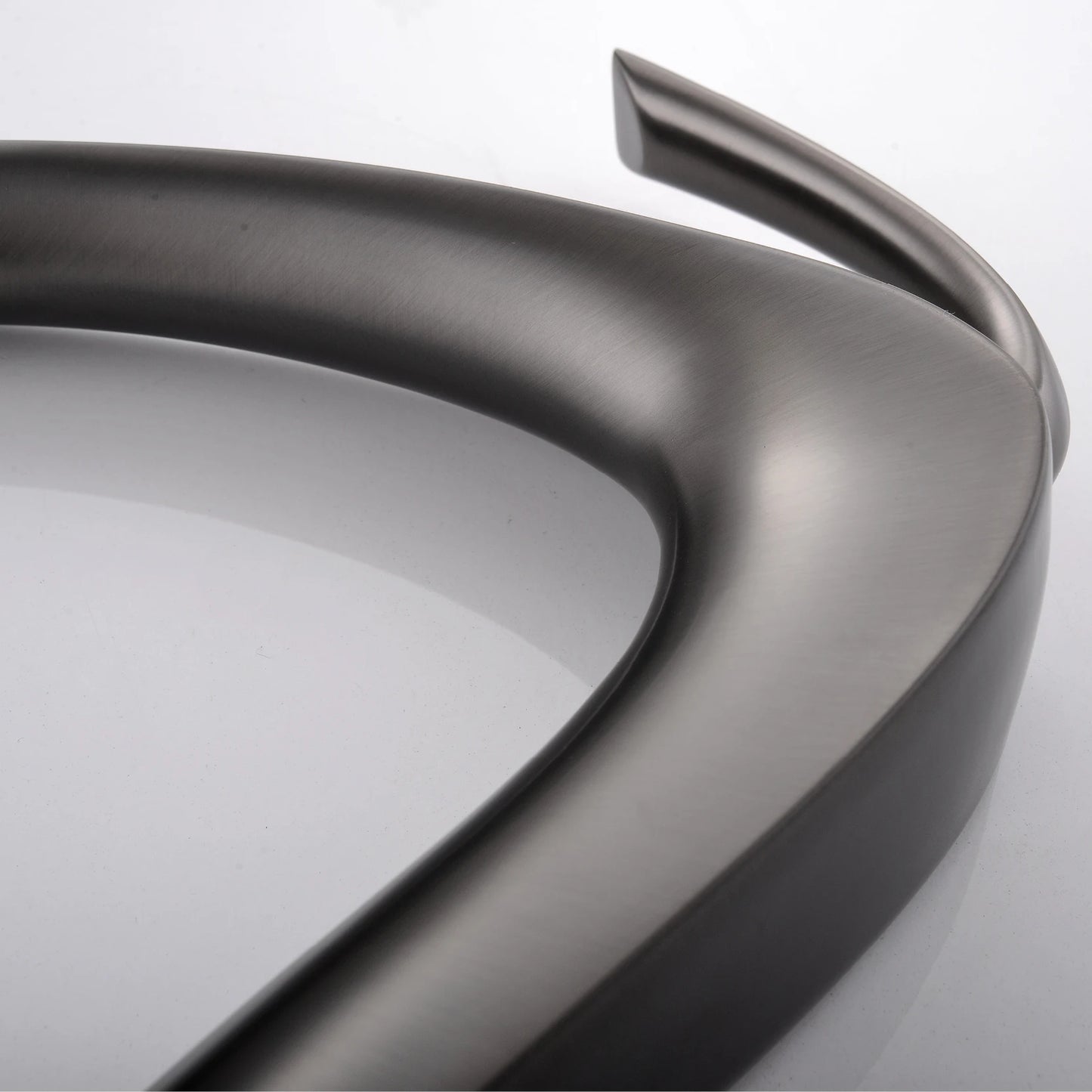 Close-up of a metallic car bumper on a white background