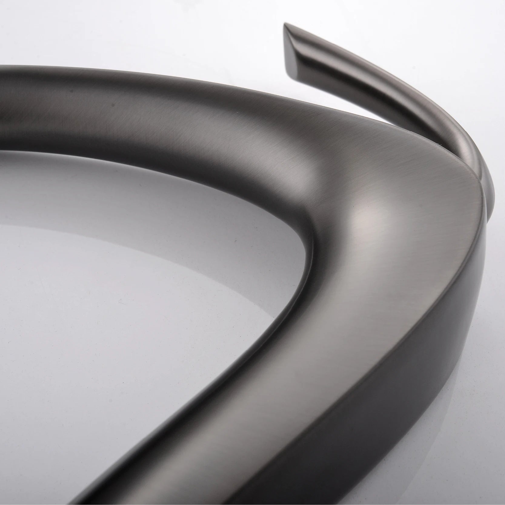 Close-up of a metallic car bumper on a white background