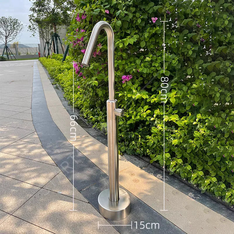 Stainless steel handrail against a green hedge with measurements indicated