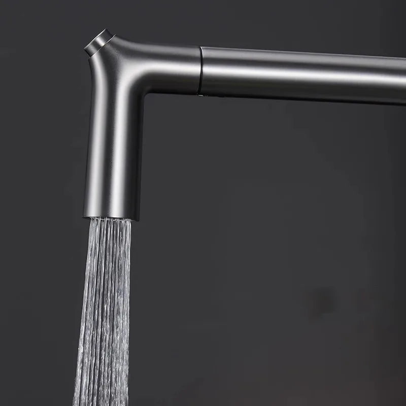 Shower head with water flowing against a dark background