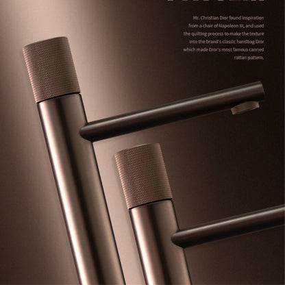 Close-up of a metallic handle design with text on a dark background
