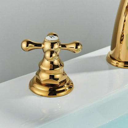 Gold faucet handle on a white sink with a gray background
