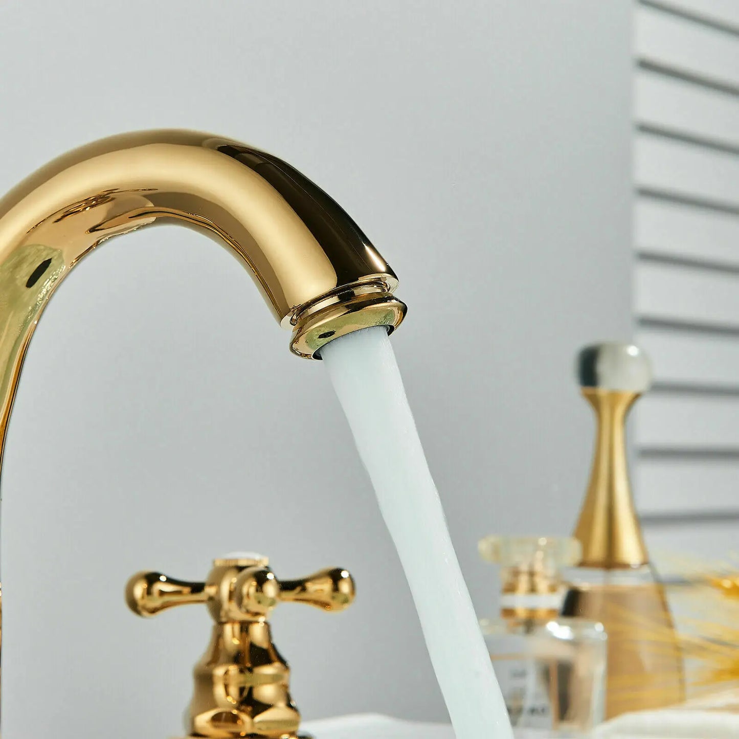 Gold faucet with water flowing in a bathroom setting