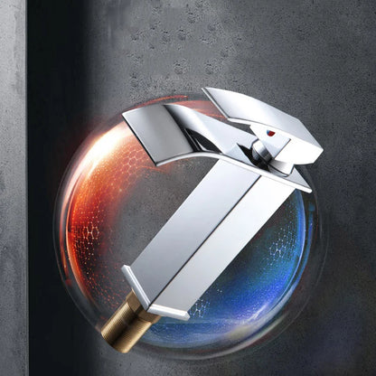 Chrome faucet with gold base on a dark background