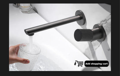 Black faucet mounted on a white sink with a hand holding a glass of water.