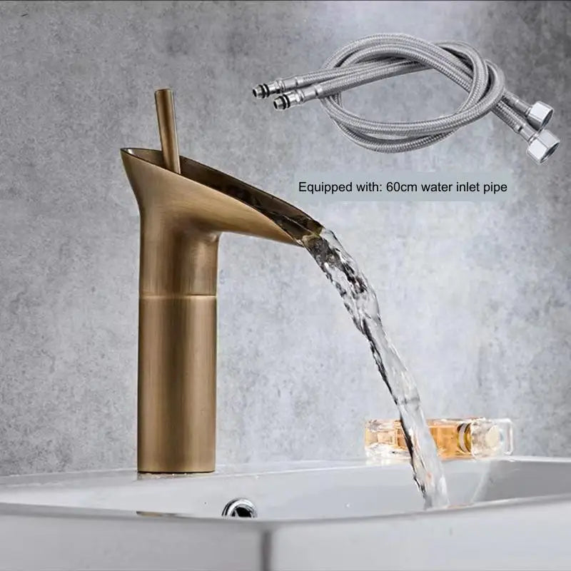 Gold faucet with water flowing and a hose on a gray background