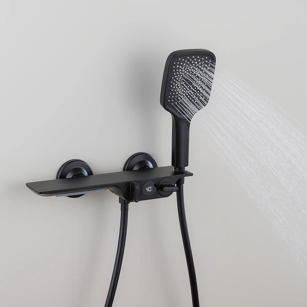 Black shower head and control panel on a light gray wall