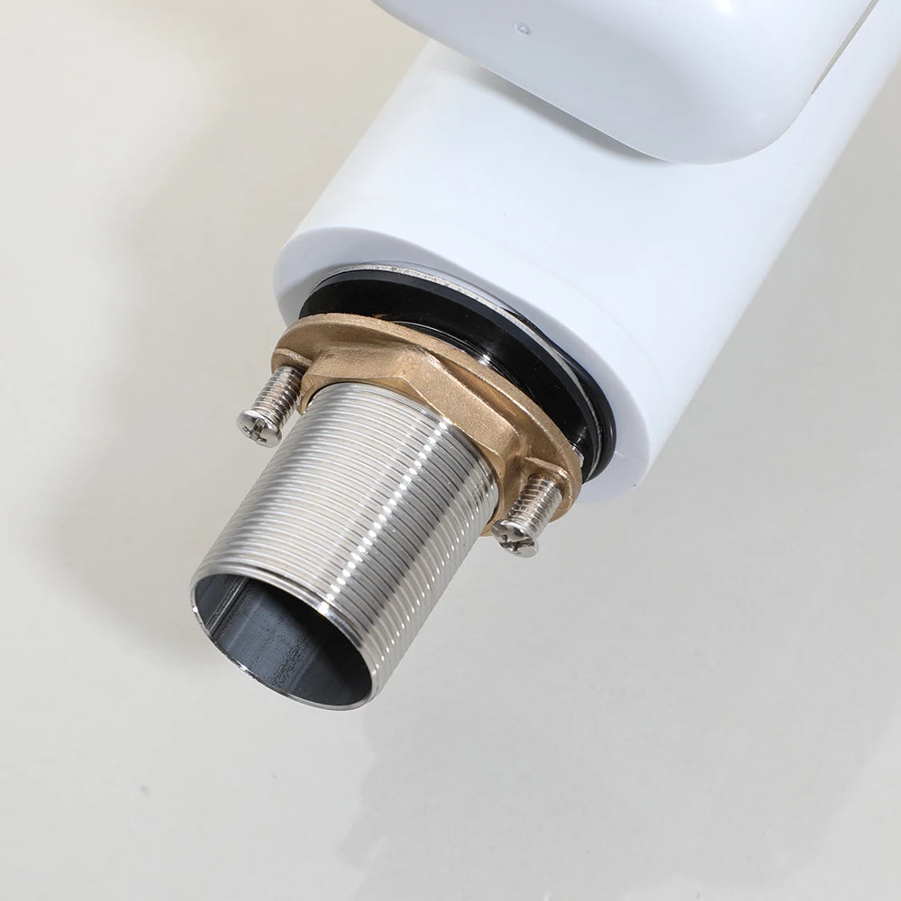Close-up of a plumbing fixture with a white cylindrical component and metallic fitting on a light background.