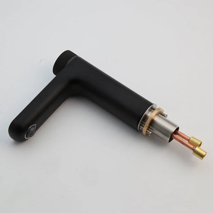 Black metal tool with cylindrical component on a light gray background